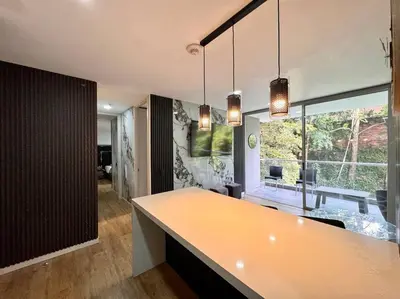 a kitchen with a counter and a large window at Urban studios luxurious apartment in the poblado in Medellín