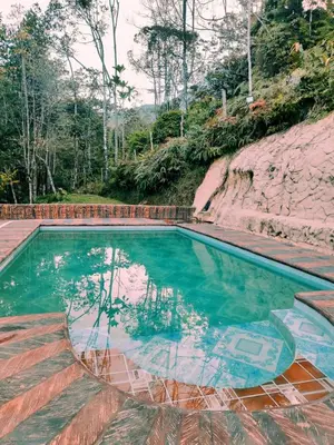 a swimming pool with a reflection in the water at Finca el Eden in San Luis
