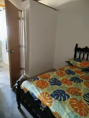 a bedroom with a bed with a colorful bedspread at Finca el Eden in San Luis