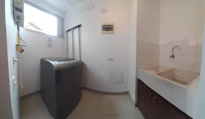 a bathroom with a sink and a washer at Lujoso y Economico Apartamento in Envigado