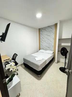 a bedroom with a bed and a desk with a desk at Verde Primavera in Guayaquil