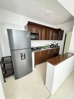 a kitchen with a stainless steel refrigerator in it at Verde Primavera in Guayaquil
