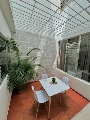 a white table and chairs on a patio with plants at Verde Primavera in Guayaquil