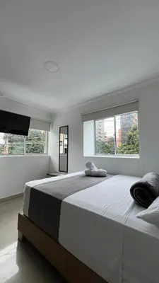a bedroom with a large bed with two pillows on it at Hotel Medellín 66 in Medellín