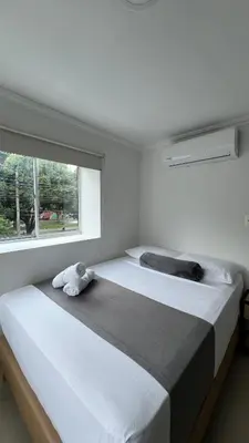 a bedroom with a large bed with a window at Hotel Medellín 66 in Medellín