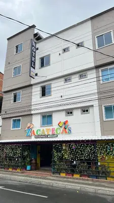 a large white building with a sign on it at Hotel Medellín 66 in Medellín