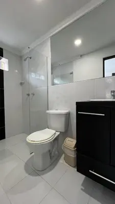 a white bathroom with a toilet and a shower at Hotel Medellín 66 in Medellín