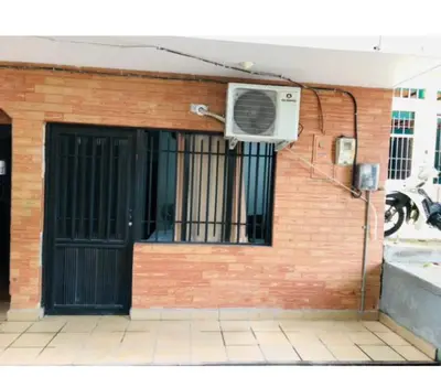 a building with a door and an air conditioner at Habitacion ,Aire, Netflix cerca Santorini in Doradal