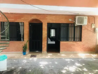 a brick house with a door and a balcony at Habitacion ,Aire, Netflix cerca Santorini in Doradal