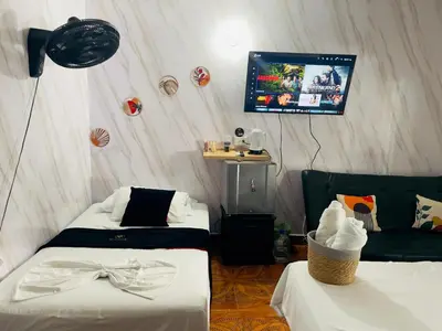a room with two beds and a flat screen tv at Habitacion ,Aire, Netflix cerca Santorini in Doradal