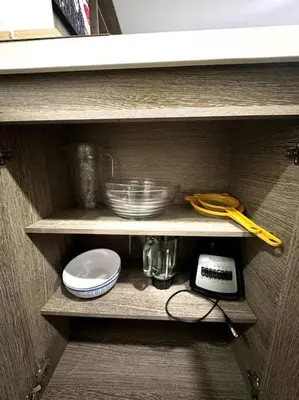 a shelf with bowls and other kitchen items on it at El Tesoro Apto in Poblado in El Poblado