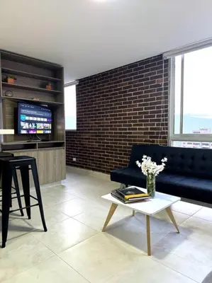a living room with a couch and a table at El Tesoro Apto in Poblado in El Poblado