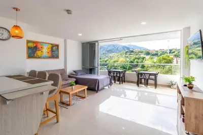 a living room with a couch and a table at Mountain View Pool & Slide AC 5min to Town in Santa Fe de Antioquia