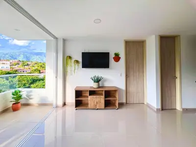 a living room with a tv and a large window at Mountain View Pool & Slide AC 5min to Town in Santa Fe de Antioquia