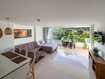a living room with a couch and a table at Mountain View Pool & Slide AC 5min to Town in Santa Fe de Antioquia