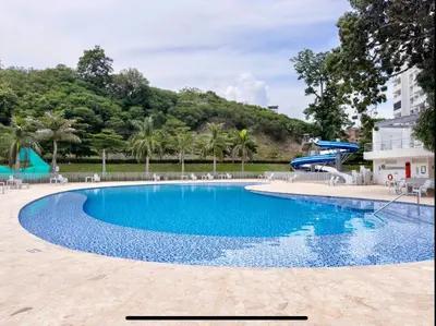 a blue swimming pool with chairs and a slide at Mountain View Pool & Slide AC 5min to Town in Santa Fe de Antioquia