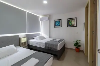 a small room with two beds and a window at Mountain View Pool & Slide AC 5min to Town in Santa Fe de Antioquia