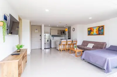 a bedroom and living room with a bed and a kitchen at Mountain View Pool & Slide AC 5min to Town in Santa Fe de Antioquia