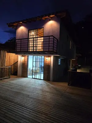 a house with a balcony and a deck at night at Sedonascapes in Palmitas