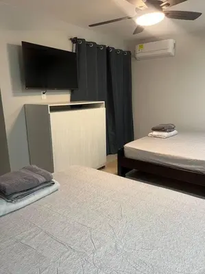 a room with two beds and a flat screen tv at Apartamento Luxury Luxury apt in Medellín