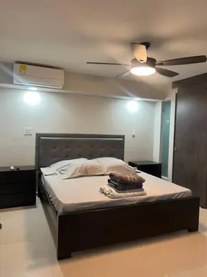 a bedroom with a bed with a ceiling fan at Apartamento Luxury Luxury apt in Medellín