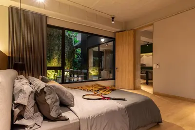 a bedroom with a bed with a tennis racket on it at Forever W&L Apartments in El Poblado