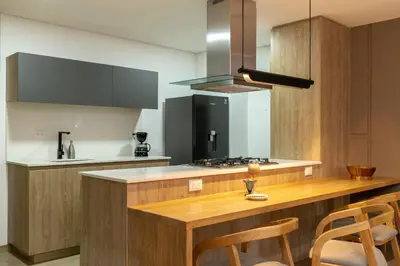 a kitchen with a wooden island with a counter top at Forever W&L Apartments in El Poblado