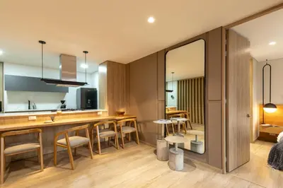 a kitchen and living room with a bar and chairs at Forever W&L Apartments in El Poblado