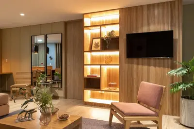 a living room with a television on a wall at Forever W&L Apartments in El Poblado