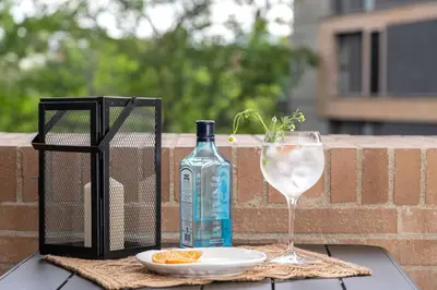 a bottle of wine and a glass on a table at Forever W&L Apartments in El Poblado