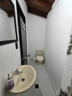 a bathroom with a sink and a toilet at Casa luz in Medellín