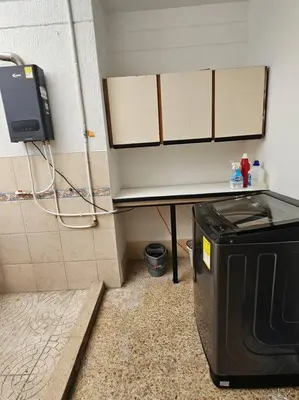 a bathroom with a counter and a trash can at Casa luz in Medellín