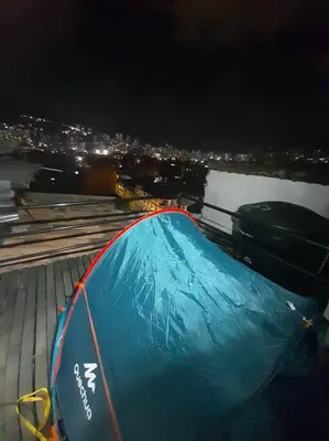 a blue tent on top of a building at night at Dúplex con hermosa vista a la ciudad deck exterior in Itagüí