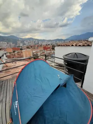 a blue tent sitting on top of a roof at Dúplex con hermosa vista a la ciudad deck exterior in Itagüí