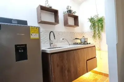 a kitchen with a sink and a refrigerator at aparta-estudio cerca estación metro poblado in Belén