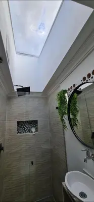 a bathroom with a shower with a sink and a mirror at aparta-estudio cerca estación metro poblado in Belén