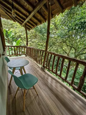 a table and a chair on a porch at Caminos Alojamiento in Jardin