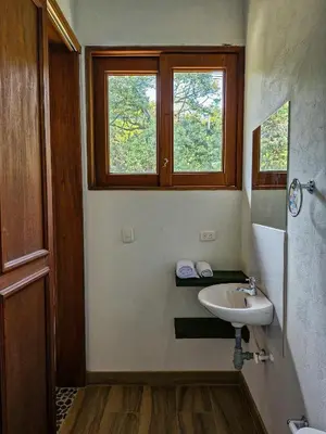 a bathroom with a sink and a window at Caminos Alojamiento in Jardin