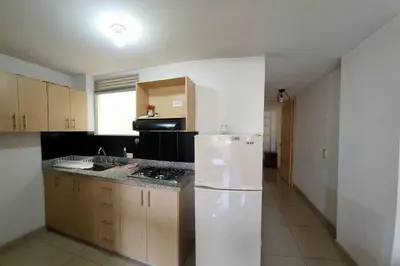 a kitchen with a white refrigerator in a room at Vivienda Céntrica y Acogedora in Sabaneta