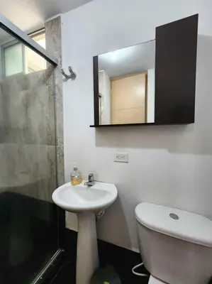 a bathroom with a sink and a toilet and a mirror at Vivienda Céntrica y Acogedora in Sabaneta