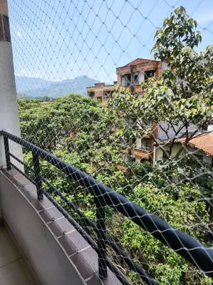 a view of a building from a balcony with a fence at Vivienda Céntrica y Acogedora in Sabaneta
