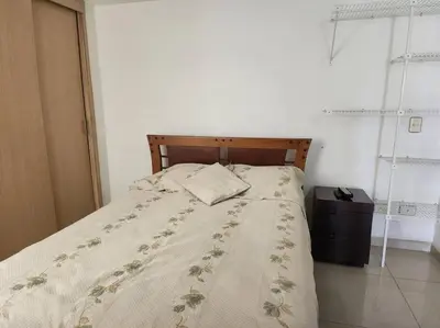 a bed in a white bedroom with a bedspread and pillows at Vivienda Céntrica y Acogedora in Sabaneta