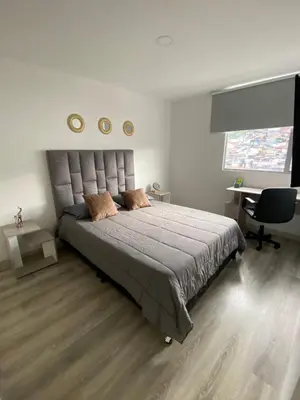 a bedroom with a large bed and a desk at Excelente ubicación y vista in Manizales