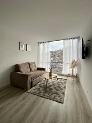 a living room with a couch and a table at Excelente ubicación y vista in Manizales