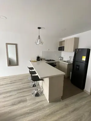 a kitchen with a counter and a black refrigerator at Excelente ubicación y vista in Manizales