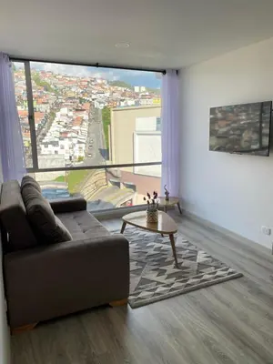 a living room with a couch and a table at Excelente ubicación y vista in Manizales