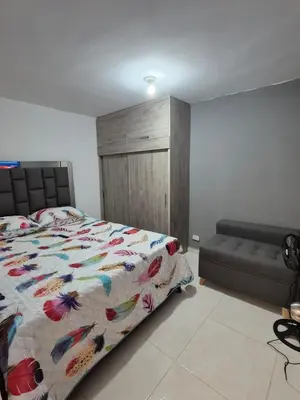 a bedroom with a bed with a colorful comforter at Apartamento Super Exclusivo in Medellín