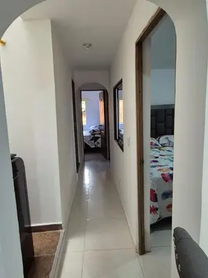 a hallway leading to a bedroom with a bed at Apartamento Super Exclusivo in Medellín