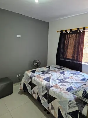 a bedroom with a bed with a quilt on it at Apartamento Super Exclusivo in Medellín