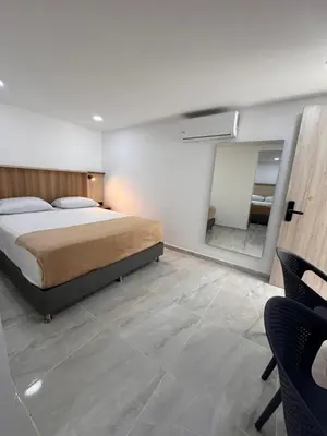 a bedroom with a bed and a mirror at Vida Hostel in Medellín